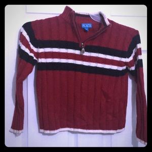 Red sweater with red black white stripes